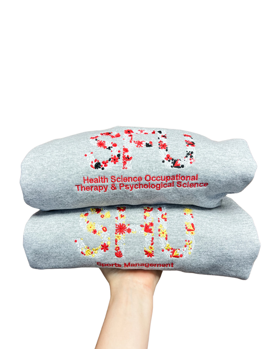 Two gray sweatshirts with colorful text and graphics on a white background
